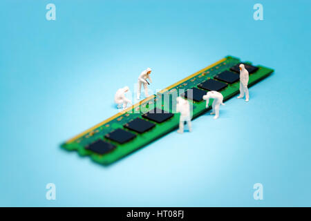 Miniature technicians repairing computer RAM module. Macro photo Stock Photo