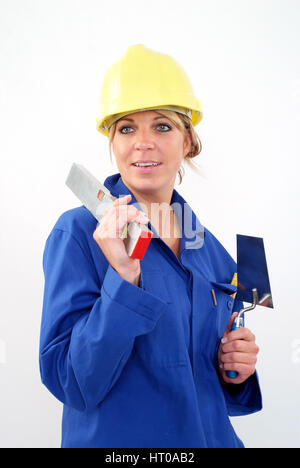 Frau als Handwerkerin mit Blaumann und Bauhelm - woman as building worker Stock Photo