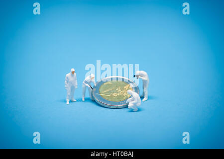Two euro coins being inspected by specialist. Stock Photo