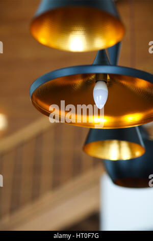 Black pendant lamp on ceiling wood wall. Close up Stock Photo