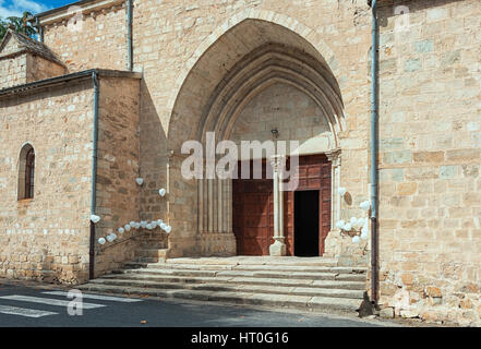 For a wedding is the entrance of a church in Largentiere in the Ardeche region of France, decorated with white heart-shaped balloons Stock Photo