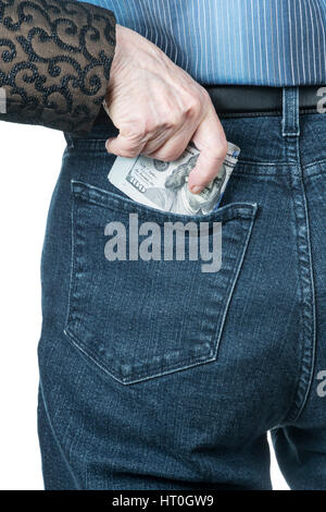 Hand hides the dollars in his pocket Stock Photo