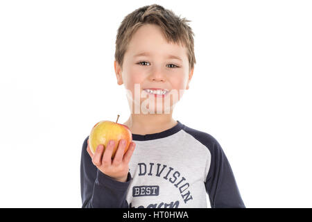 Smiley happy little boy holding an apple in his hand. Isolated on a white background. Stock Photo