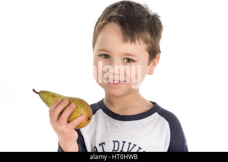 Smiley happy little boy holding a pear in his hand. Isolated on a white background. Stock Photo