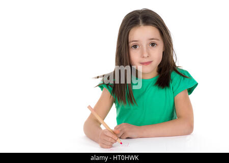 School girl drawing a picture with a crayon. Isolated on a white background. Stock Photo