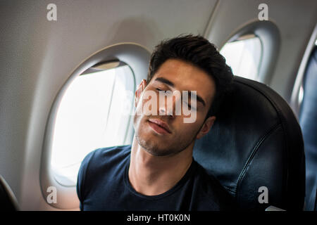 Young man in plane Stock Photo