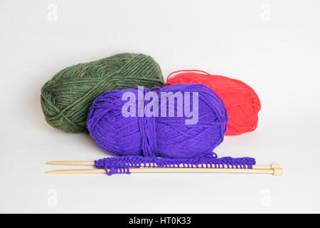 Three Colorful Balls of Yarn with Two Knitting Needles Stock Photo