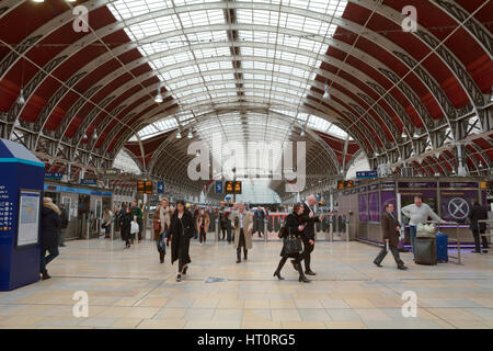 Passengers arriving and departing from Paddington Railway Station in London England - the station has lots of departure and arrival boards Stock Photo