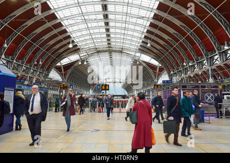 Passengers arriving and departing from Paddington Railway Station in London England - the station has lots of departure and arrival boards Stock Photo