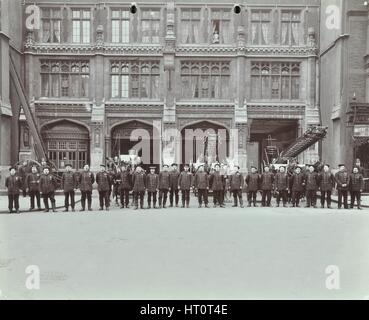 Firemen lined up outside Bishopsgate Fire Station, Bishopsgate, City of London, 1908. Artist: Unknown. Stock Photo
