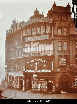 Illuminated advertisements on shop fronts at 7, Oxford Street, London, 1909. Artist: Unknown. Stock Photo
