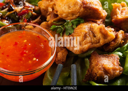 Fried chicken pieces in batter on a plate Stock Photo