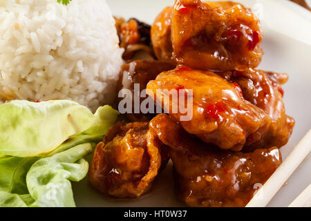 Fried chicken pieces in batter with sweet and sour sauce Stock Photo