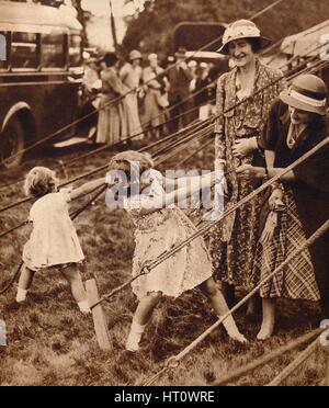 Princess Elizabeth and Princess Margaret pull their weight, 1930s (1935). Artist: Unknown. Stock Photo