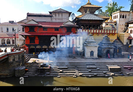 PASHUPATINATH - OCTOBER : Cremation ghats and ceremony along the holy Bagmati River. Hundreds of earthquake victims were cremated here after the catas Stock Photo