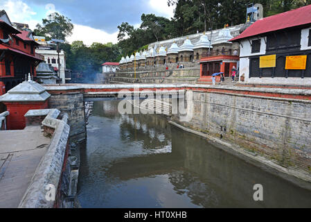 PASHUPATINATH - OCTOBER : Cremation ghats and ceremony along the holy Bagmati River. Hundreds of earthquake victims were cremated here after the catas Stock Photo
