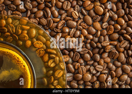 A cup of coffee with beans as background. Stock Photo