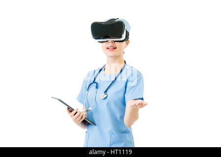 asian female surgeon use digital tablet control virtual reality touch screen. VR headset glasses device. white isolated background. medical and health Stock Photo