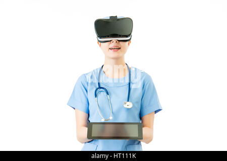 asian female surgeon show digital tablet presenting virtual reality. VR headset glasses device. white isolated background. medical and health concept Stock Photo