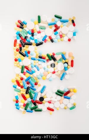 Top view of letter E made from medical pills and capsules, medicine and healthcare concept Stock Photo