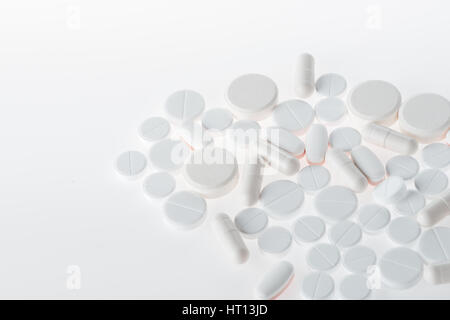 Assortment of white medical tablets and capsules, medicine and healthcare concept Stock Photo