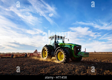 Varna, Bulgaria - March 5, 2017 Ploughing a field with John Deere 6930 tractor. John Deere was manufactured in 1995-1999 and it has JD 7.6L or 8.1L 6- Stock Photo