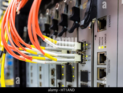 Fiber optic cable connect to ethernet switch mount on rack Stock Photo