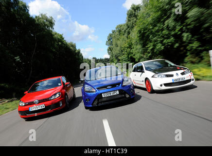 VW Golf GTi Renault Megane Sport R26R and Ford Focus RS 2009. Artist: Simon Clay. Stock Photo