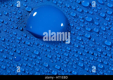 water drops on blue background creating shinny light effect Stock Photo