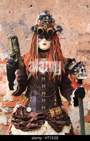 A steampunk girl with pistol and walking stick during the Carnival in Venice, Italy Stock Photo
