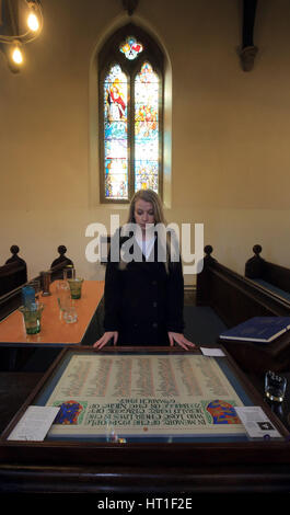 Kim Spooner, niece of Neil Spooner and Mary Smith who died in the Zeebrugge ferry disaster, reads a memorial board with the names of those who died in the disaster ahead of a service at St Mary's Church in Dover, Kent, marking the 30th anniversary. Stock Photo