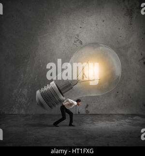 Businessman holds a big light bulb. Have a great idea to be realized concept Stock Photo