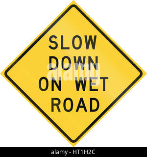 Road sign used in the US state of Texas - Slow down on wet road. Stock Photo