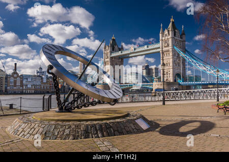 The Tower Hotel Sundial, designed by Wendy Taylor, with Tower Bridge in the background on a cold but bright day in the capital city of London. Stock Photo
