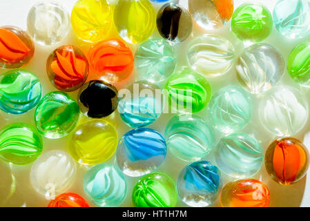 Closeup of multi colored glass beads on white background Stock Photo