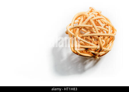 A wicker ball with soft shadow, isolated on white. Free space for text. Stock Photo