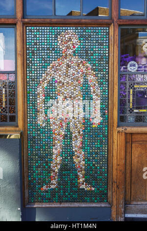 Human figure created from beer bottle tops. Bottle top art. Bottle cap art. Art and crafts design. Upcycle. Bottle cap mosaic. Bottle cap crafts. Stock Photo