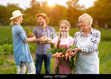 Satisfied rural family with own produced vegetables Stock Photo