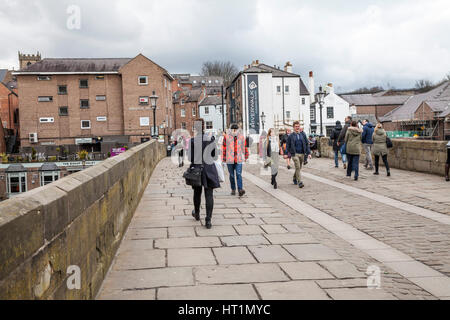 People walking across Old Elvet bridge in Durham city center,England,UK Stock Photo