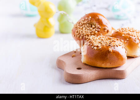 Freshly cooked homemade mini brioche buns on festive Easter table Stock Photo