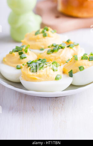 Homemade creamy deviled eggs topped with green onion, perfect Easter party snack Stock Photo