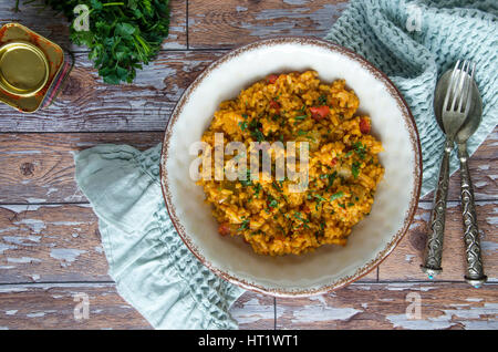 Spanish paella with artichokes and roasted red peppers Stock Photo