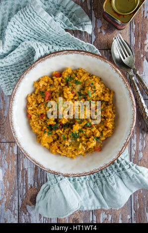 Spanish paella with artichokes and roasted red peppers Stock Photo