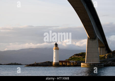 Kyleakin Lighthouse and Skye Bridge across Loch Alsh linking the a87 road  between Eilean Ban island and Kyle of Lochalsh on mainland in Scotland Stock Photo