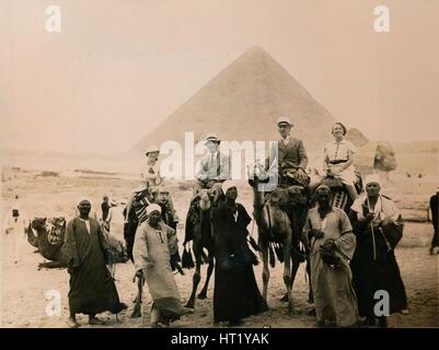 British tourists seated on camels in front of The Great Pyramid, Giza, Egypt, 1936. Artist: Unknown Stock Photo