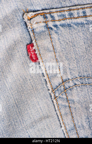 BANGKOK, THAILAND - DECEMBER 09 2014: Close up of the LEVI'S red label on the back pocket of old denim jeans. LEVI'S is a brand name of Levi Strauss a Stock Photo