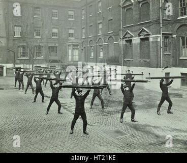 Firemen carrying out scaling ladder drill, London Fire Brigade Headquarters, 1910. Artist: Unknown. Stock Photo