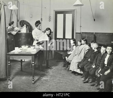 Nurse cutting children's verminous hair, Finch Street Cleansing Station, London, 1911. Artist: Unknown. Stock Photo