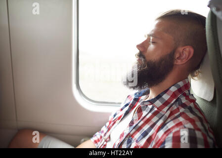 Sleeping man in the train Stock Photo