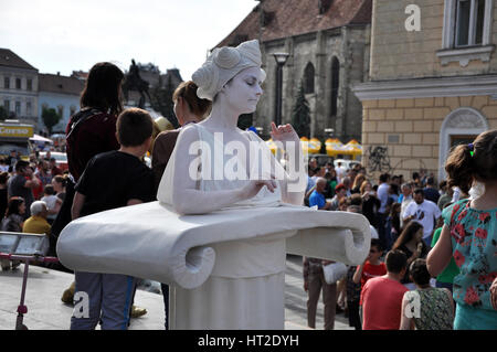 CLUJ NAPOCA - MAY 24: Living statue woman, street performer doing a busking mime inside the Man.In.Fest during the Cluj Days of Cluj. On May 24, 2015  Stock Photo
